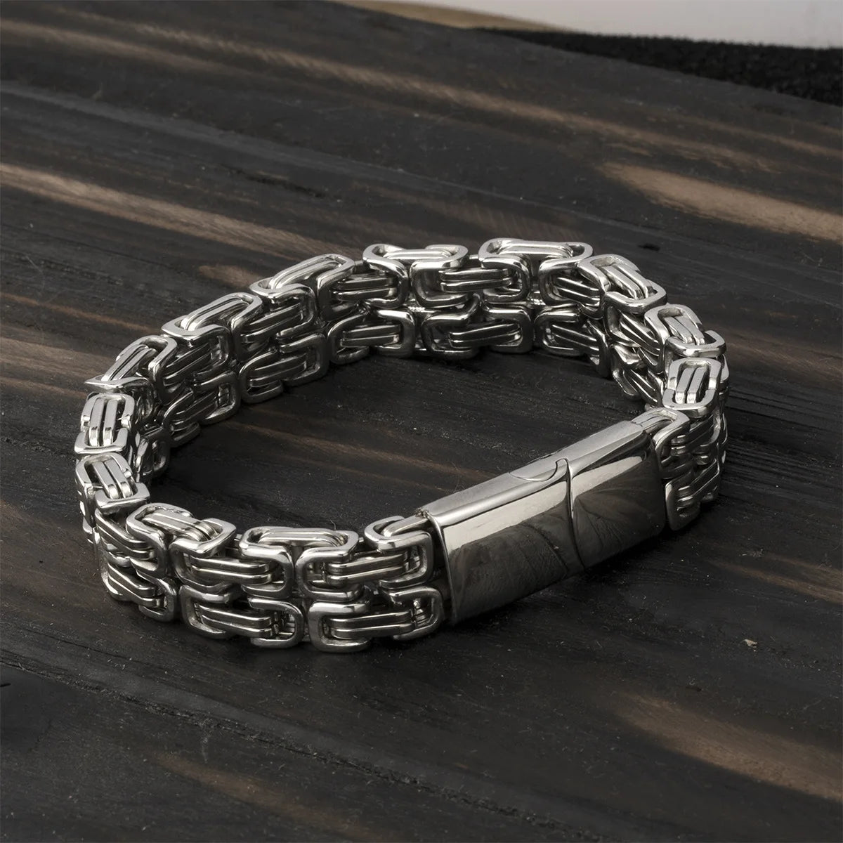 Silberfarbenes Herren-Gliederarmband geschlossen auf Holz